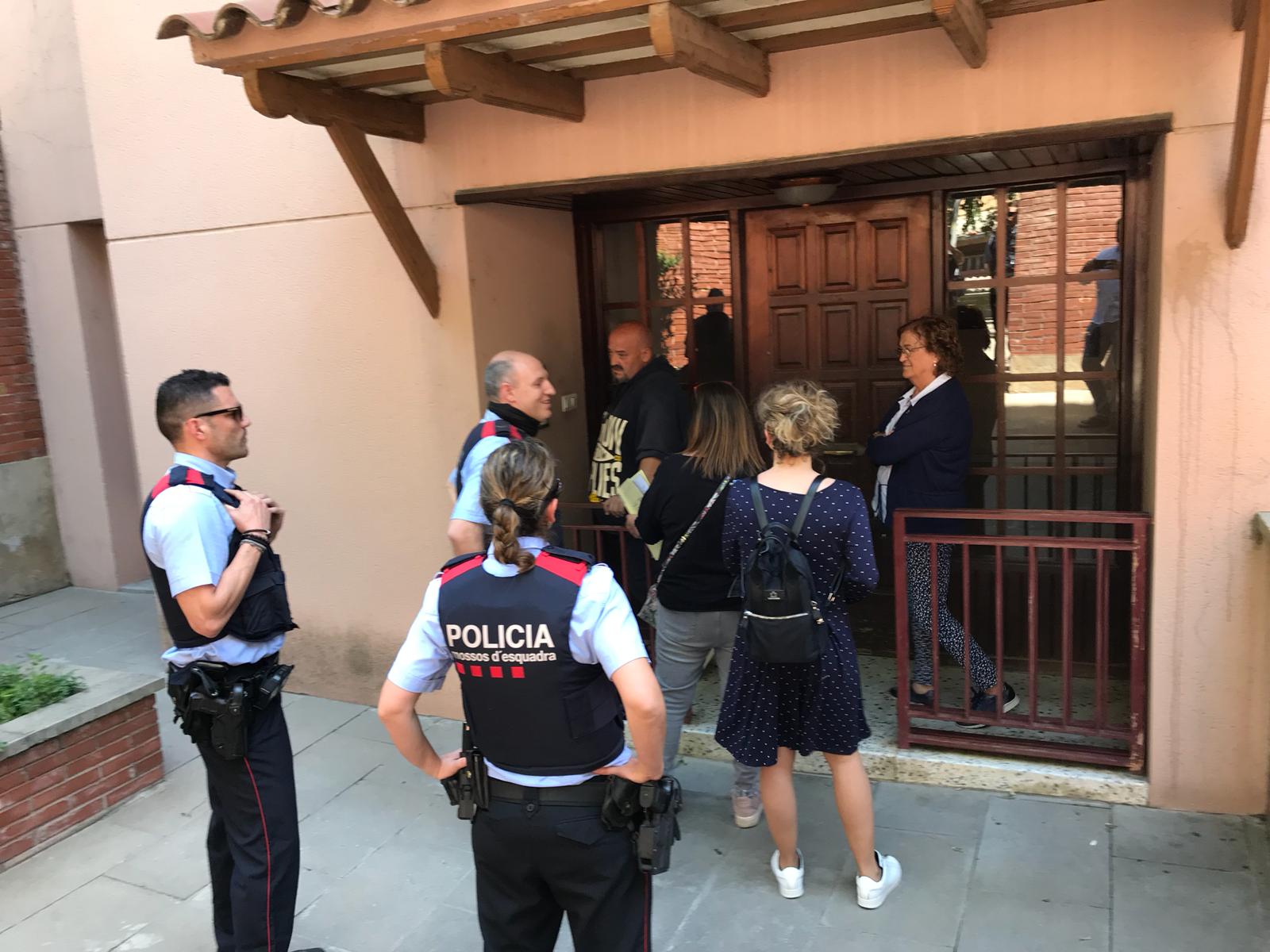Els representants de la propietat entren a l'edifici sota un cordó dels Mossos. FOTO: TOT Sant Cugat