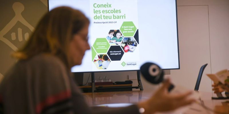 La regidora d'Educació, Pilar Gorina, amb el lema comunicatiu de l'Ajuntament per promoure les escoles del barri. FOTO: Ajuntament